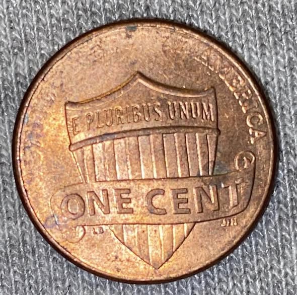 2024-D penny grease struck-through error showing missing shield stripes on the reverse