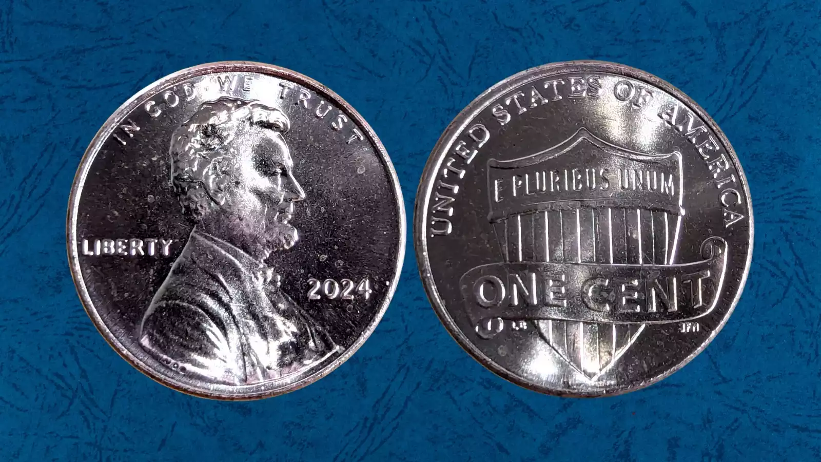 2024-D penny W-shaped gouge die error showing raised W-mark on Lincoln's coat near shoulder